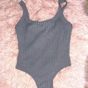 grey ribbed bodysuit, hugs body Perfectly , keeps it’s form to the end the night